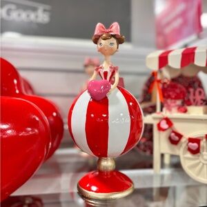 Red and White Striped Figurine with Heart